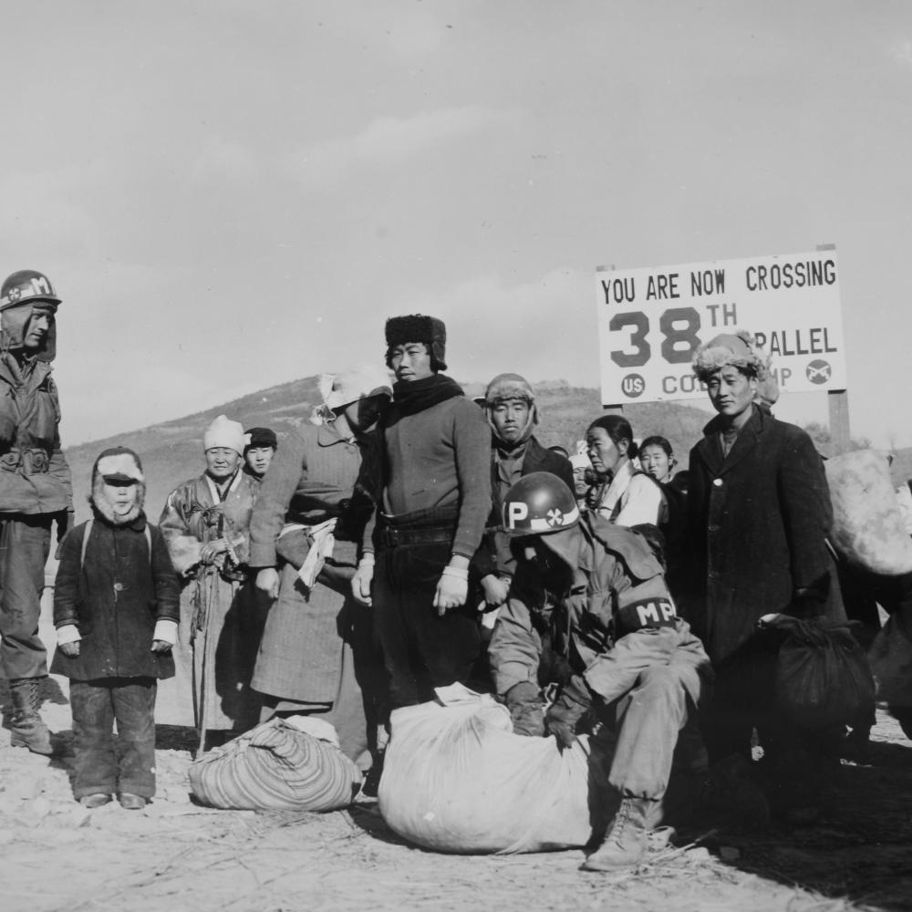 Refugees are checked for contraband by U.S. soldiers at 38th Parallel in 1950