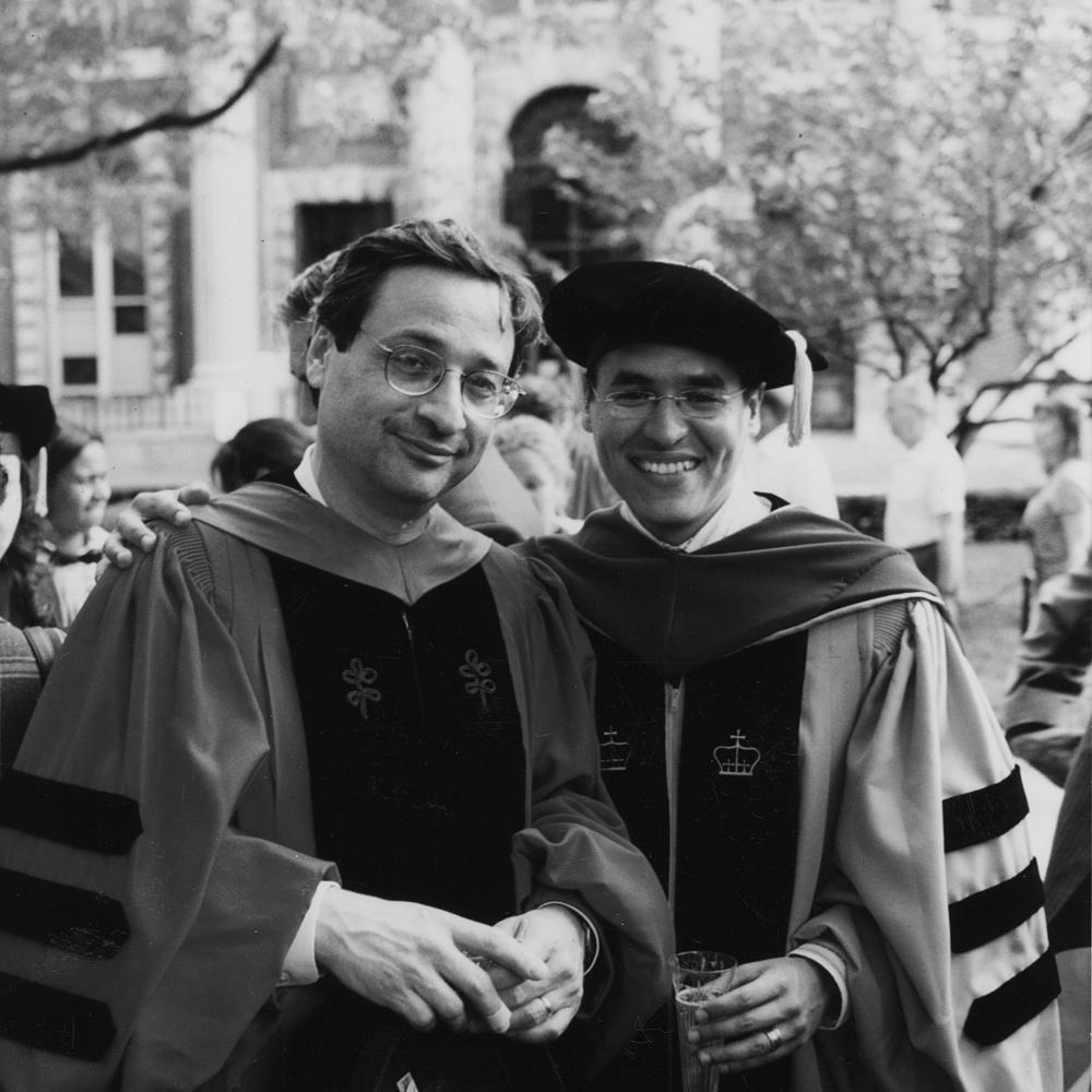 black and white photo of two professors in robes during a graduation ceremony