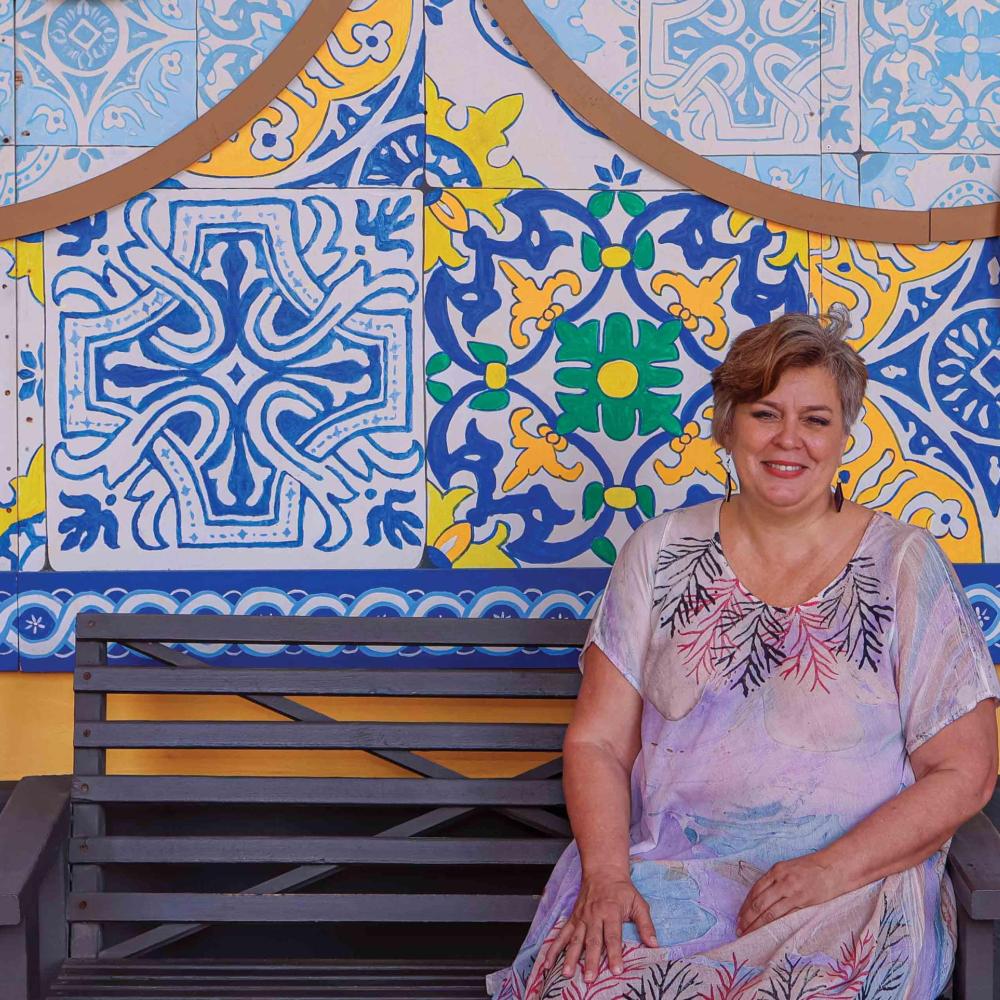 woman in front of colorful tiled wall in Puerto Rico