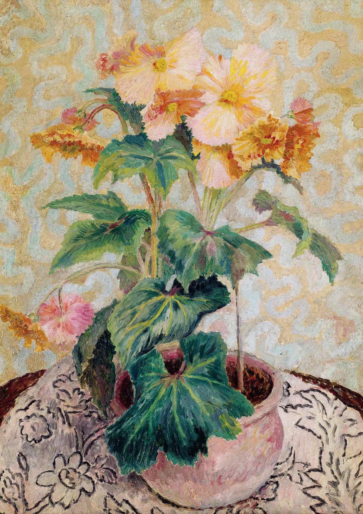 A bouquet of yellow begonias in a round clay pot, sitting on a table covered with a black and white floral tablecloth