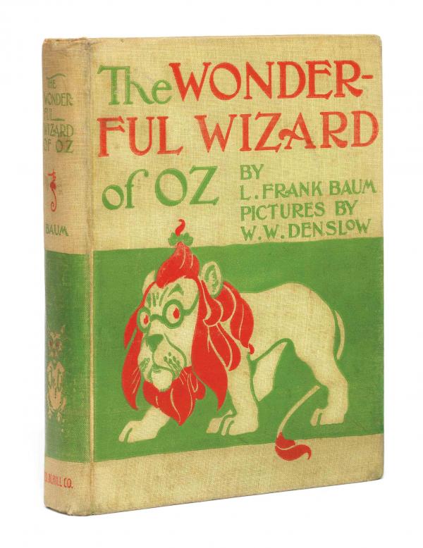 The 1900 First Education of L. Frank Baum's classic children's novel The Wonderful Wizard of OZ. It is yellow with red and green text and lion is depicted in yellow, green, and red with a green background.
