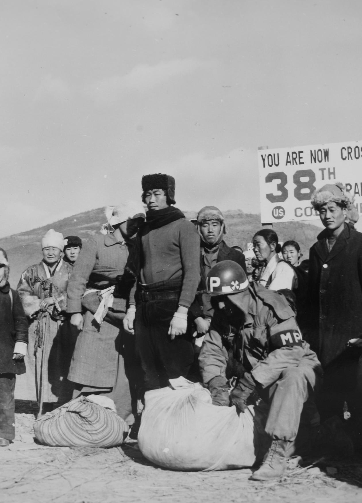 Refugees are checked for contraband by U.S. soldiers at 38th Parallel in 1950