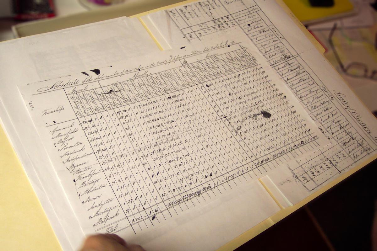 A piece of paper printed with a table of data, with handwritten notes