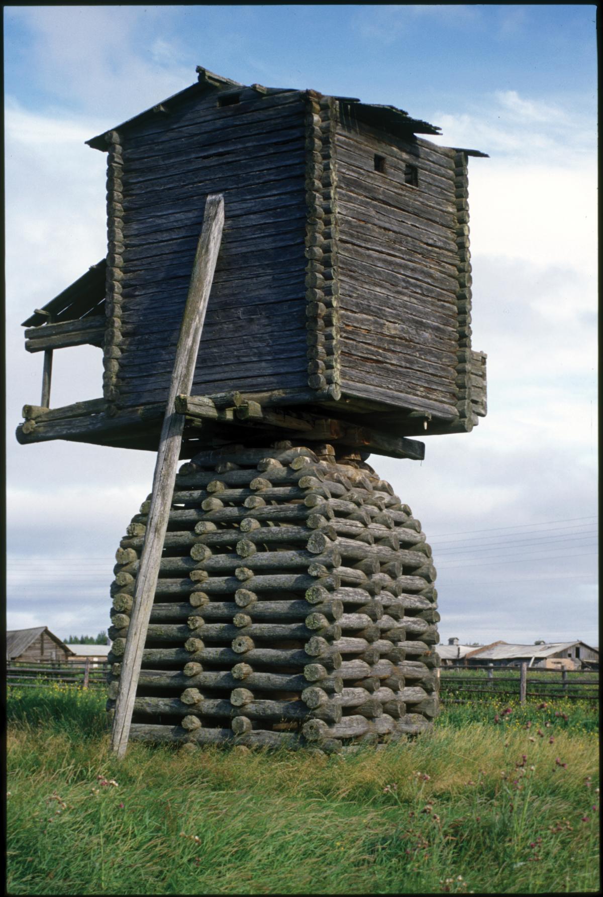 Photograph of a large windmill made out of logs