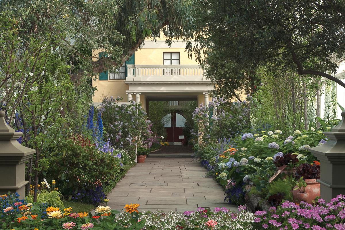 Photograph of a stone path surrounding by flowers leading up to the door of a house