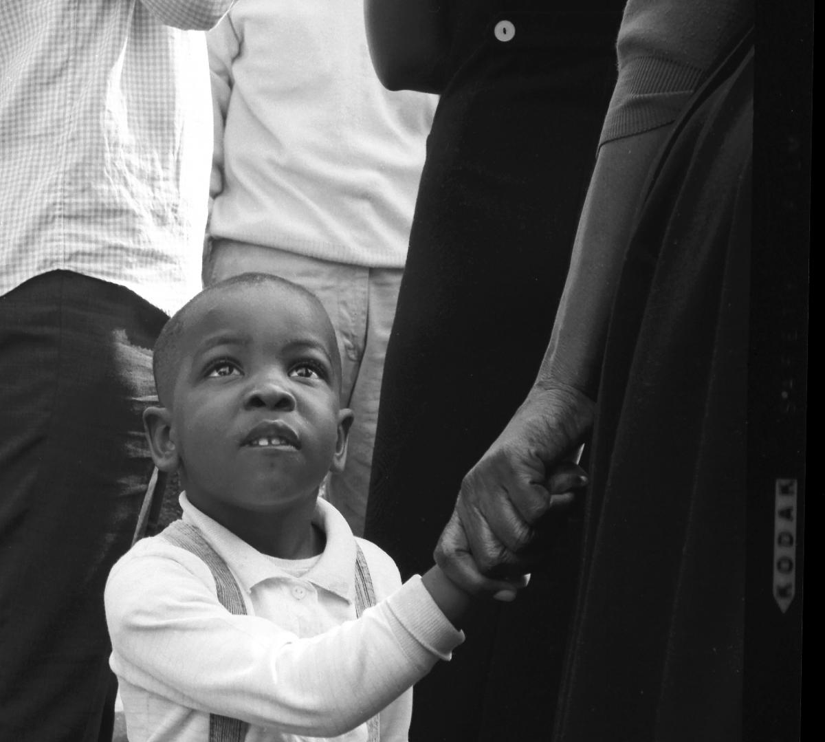 Williams photo of young boy clutching hand 