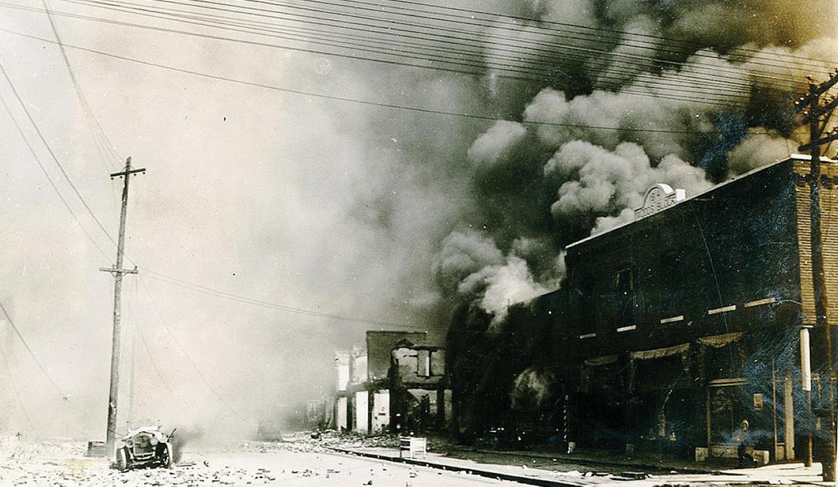 Smoke engulfs a building as a fire rages in Greenwood.