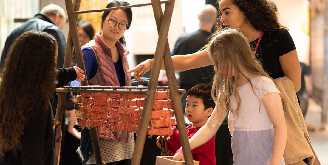 Visitors tour the Our Material World exhibit of the Burke Museum