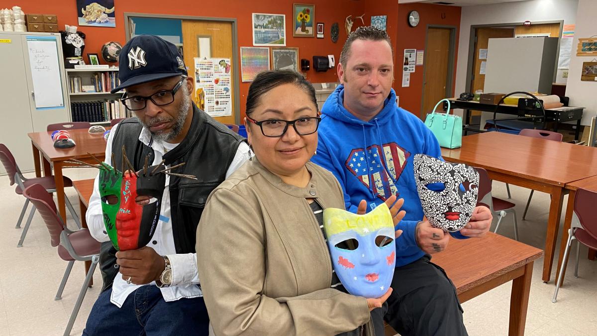 three students with their masks