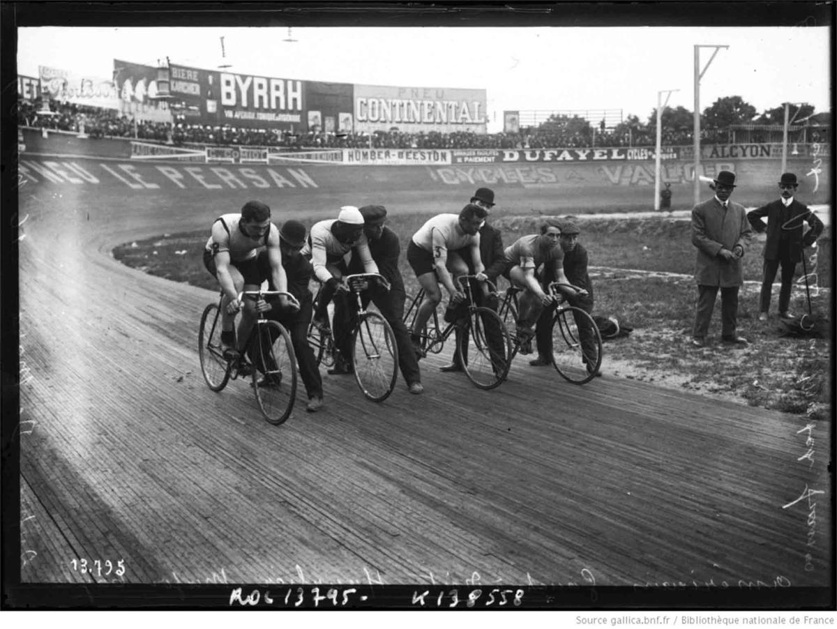 Taylor, second cyclist from left, held by his trainer and ready to start.