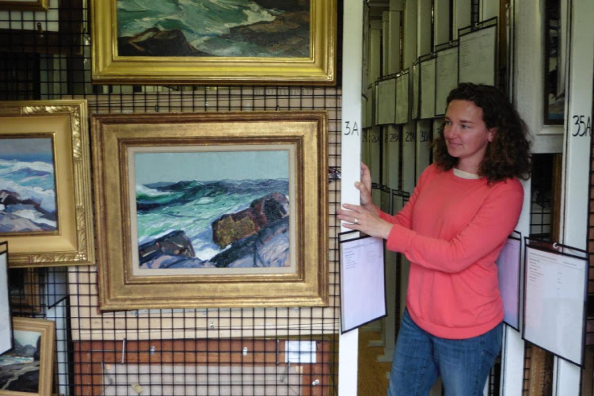 Jennifer Pye, Curator of Collections, showing the custom painting racks that were built using the same mesh that is used to make lobster traps.