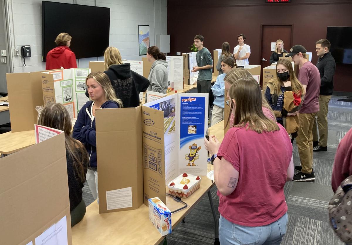 students at Virginia Tech in front of cardboard presentation posters for food minor program 