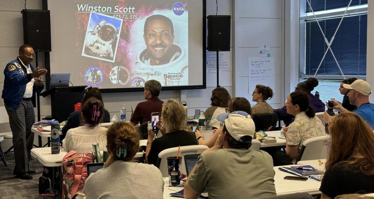 teachers in classroom listen to astronaut Winston Scott 