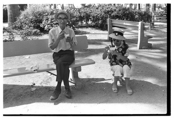 Two elderly people eating snowcones