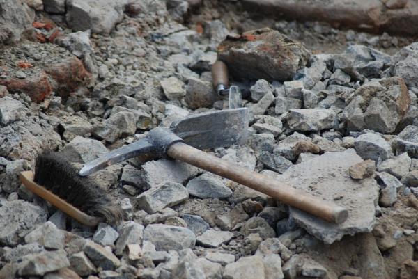 Archaeology tools lying on rocky ground