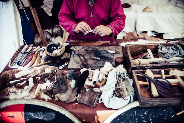 Table strewn with knives and crafted items