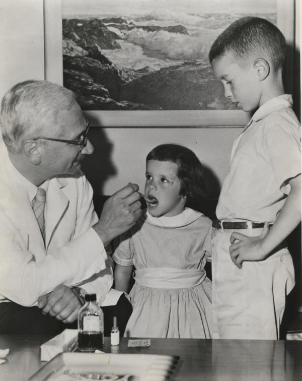 Dr. Sabin administers his oral vaccine to two Cincinnati children, ca. 1960.