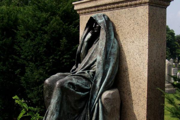 Stone sculpture of a woman in a flowing wimple.