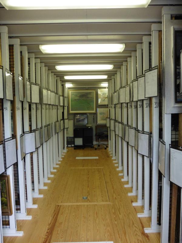 Painting vault in retrofitted Ice House with racks made from lobster trap mesh at the Monhegan Historical and Cultural Museum