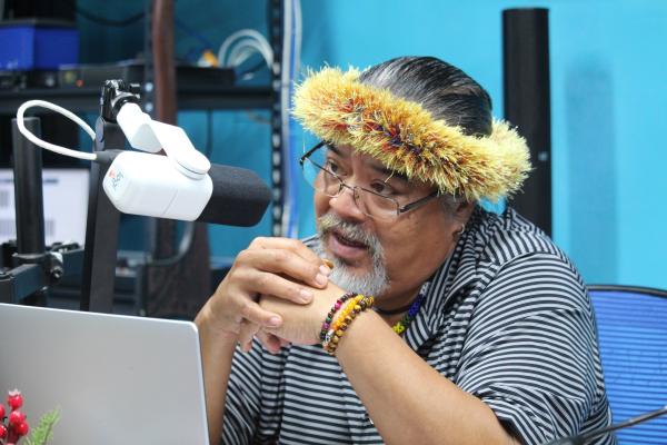 man with headdress on radio broadcast 