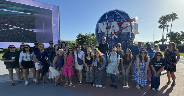 photo of group of educators in front of NASA sign