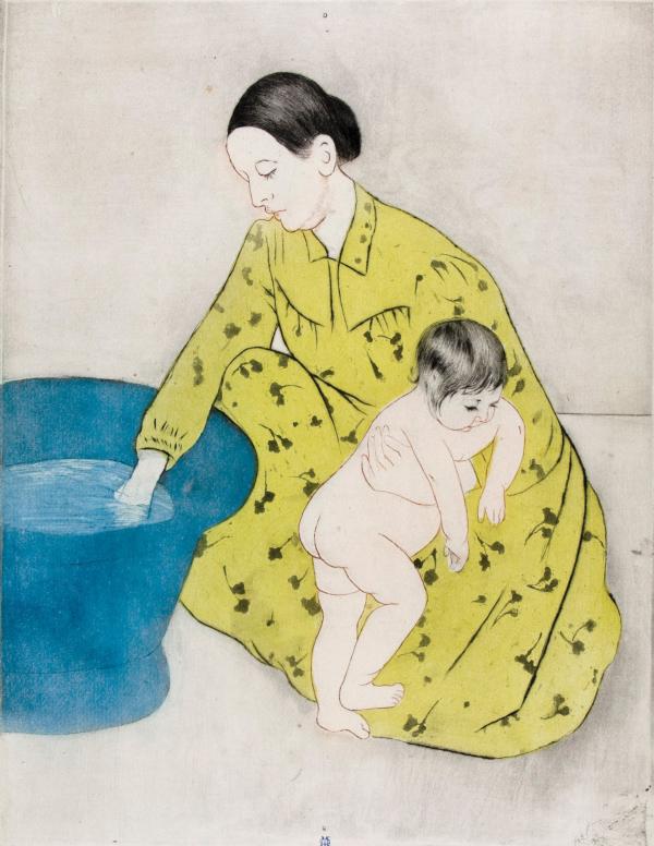 A woman bathes a baby