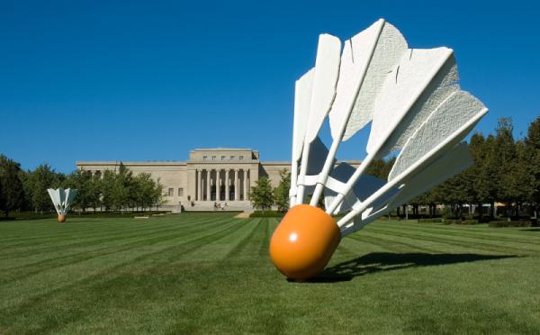 An image of the lawn of the Nelson Gallery of Art, with the building in the background and large statue of a shuttlecock in the foreground.