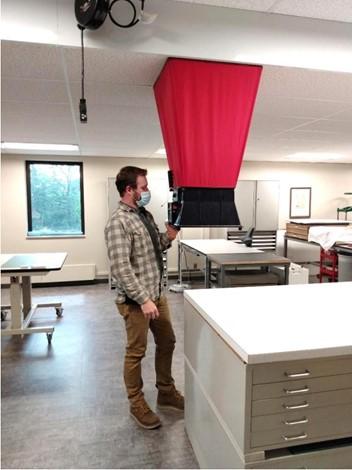 Doyle Field Services technician testing building airflow with a flow hood at the Spencer Research Library, University of Kansas.