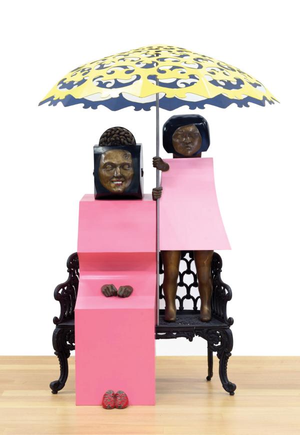 Marisol's artwork, Mama y Yo, a sculpture of a pink-clad mother and child on a bench with the child holding an umbrella over the mother's head