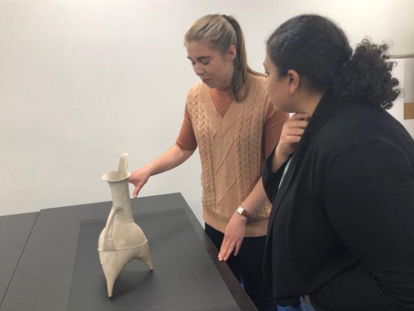 Supported by a Research and Development grant, the University of California, Los Angeles, will facilitate the voluntary return of international archaeological and ethnographic objects to their communities of origin. Here, doctoral candidates Mary Anastasi (left) and Maryan Ragheb, students in the Waystation Certificate Program, discuss a tripod pitcher from China. 