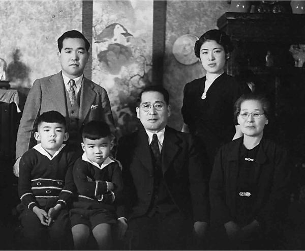 A black and white photograph of the Mihara family, including parents, grandparents, Sam, and his brother. 