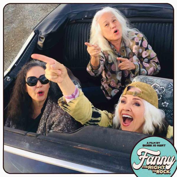 Older members of Fanny pointing and laughing in car