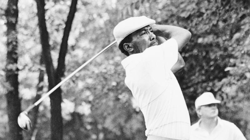 Black and white image of Calvin Peete swinging golf club