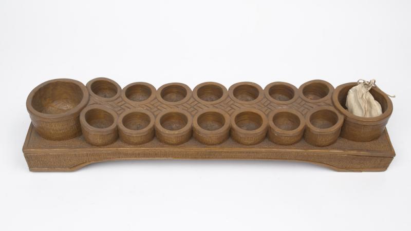 A wooden sungka board