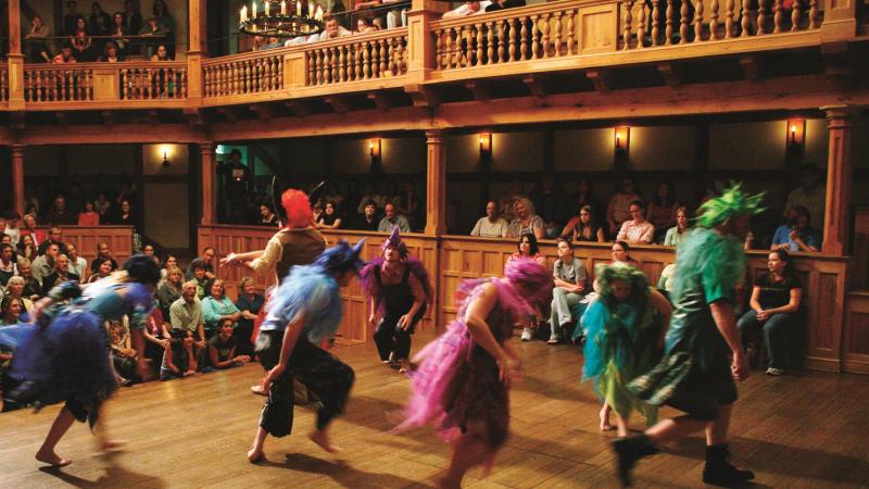 performers in colorful costumes moving around on stage