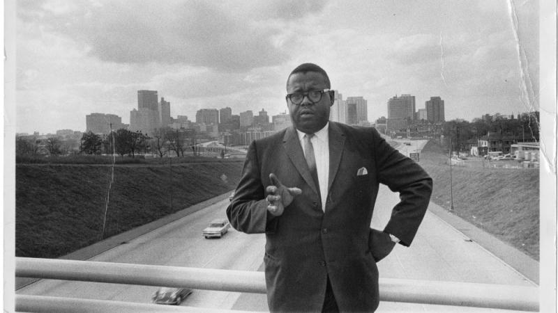 James H. Costen stands on the Spring Street bridge with the Atlanta skyline