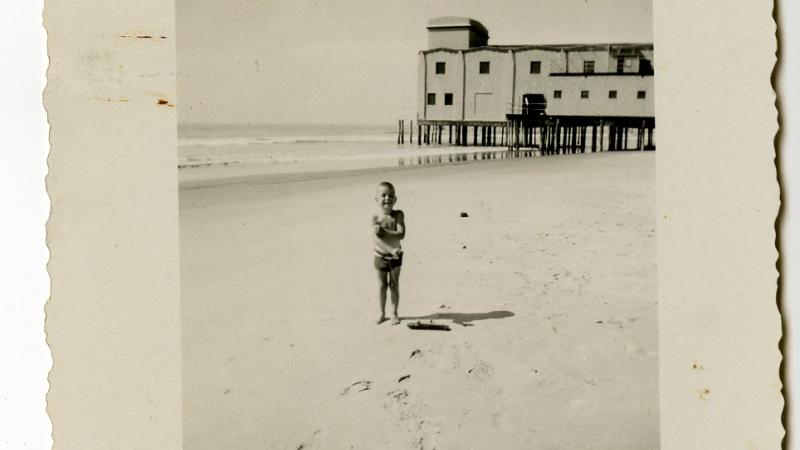 Photograph, child on 30th St. beach with Avalon Pier visible in background, 1945