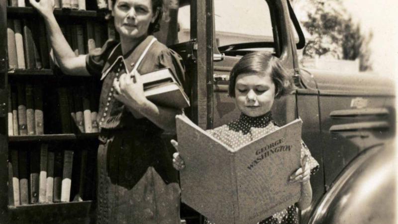 Mrs. Garrett Smith and daughter selecting books from the Rockingham County, NC bookmobile.