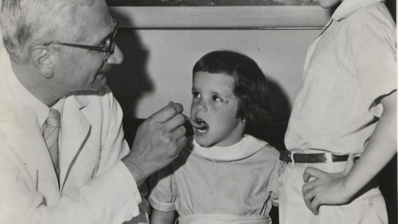 Dr. Sabin administers his oral vaccine to two Cincinnati children, ca. 1960.