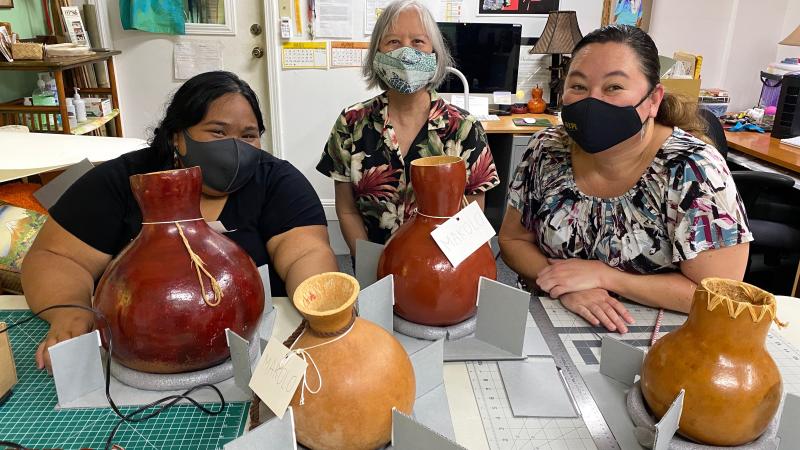 Conservator Linda Hee trains the team on housing for fragile feathered gourds called ʻulīʻulī.