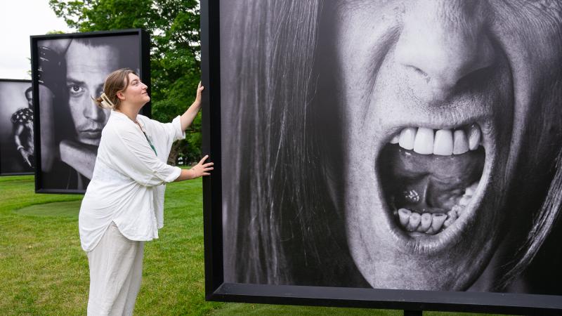 Mia Horvath during her internship at the Fenimore Art Museum in Cooperstown, showcasing a portrait from the Marc Hom: Re-Framed exhibition. 